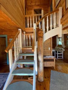 a spiral staircase in a log cabin at Meerhaus in Zingst