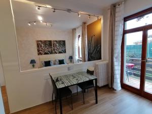 a dining room with a table and chairs and a window at CASA VACANZA IL SORRISO DEL LAGO in Avigliana +33 photos