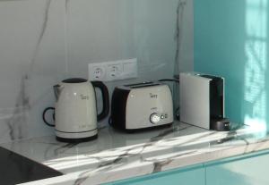 a counter with two toasters and a toaster at Asteri Apartments Mytikas 2-Bedroom Seaview Courtyard in Mitika
