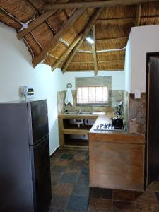 a kitchen with a stove and a refrigerator at Unique Overnight Polokwane in Polokwane