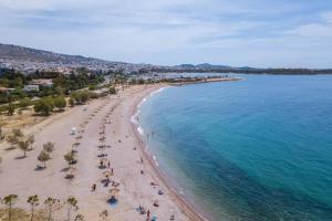 an overhead view of a beach with people and the ocean at Modern apt in Glyfada a Breath Away from the Sea - The View in Athens