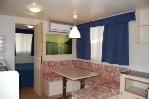 - un salon avec une table et un canapé dans l'établissement camping feniglia, à Monte Argentario