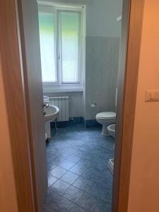 a bathroom with two toilets and a sink at Hotel Loveno in Menaggio