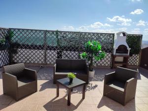 a patio with two chairs and a table on a balcony at Casa Twins in Bari