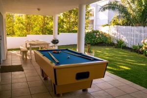 a pool table on a patio in a yard at Hermanus Family Getaway - Near The Beach in Hermanus