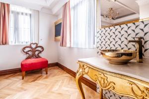 a room with a table and a red chair at Glamorous Authentic Studio in Üsküdar in Istanbul