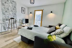 a bedroom with a large bed and a living room at Studio le homard bleu in Camaret-sur-Mer