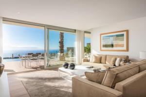 a living room with a view of the ocean at Los Jardines de Abama Suites in Guía de Isora