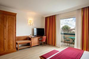 um quarto de hotel com uma secretária e uma janela em Best Western Hotel Viterbo em Viterbo