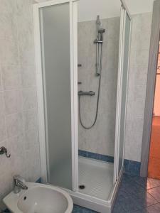 La salle de bains est pourvue d'une douche, de toilettes et d'un lavabo. dans l'établissement Hotel Loveno, à Menaggio