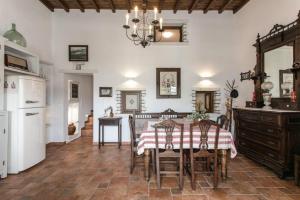 a kitchen and dining room with a table and chairs at Traditional Inn Pirethron in Apeiranthos