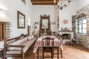 a dining room with a table and a fireplace at Traditional Inn Pirethron in Apeiranthos