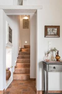 a staircase in a home with wooden floors and white walls at Traditional Inn Pirethron in Apeiranthos