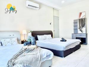a bedroom with two beds and a dresser at NEW! Atlantis Residence I D1607 Premium 2BR I 5-10pax I Swing I JonkerSt I City Centre by Jay Stay in Melaka