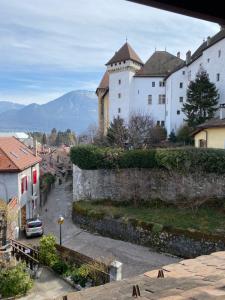 a view of a castle in a town at Hôtel du Château in Annecy