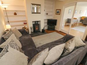 a living room with a couch and a fireplace at Netherscar in Weathercote