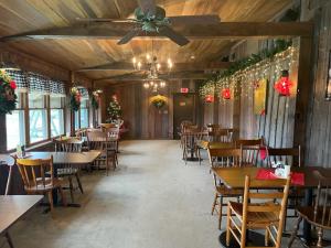 a restaurant with tables and chairs and a ceiling fan at Deer Creek Winery at Watson Estate in Uniontown