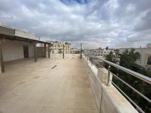 a balcony with a view of a city with buildings at Lemon Tree Residence in Amman