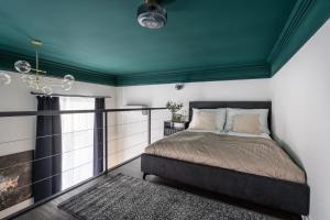 a bedroom with a bed and a green ceiling at E41- Boutique Apartments, Best Location, by BQA in Budapest