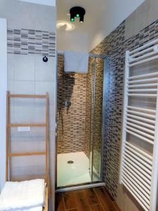 a shower with a glass door in a bathroom at VCE House in Tessera