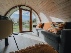 a living room with a couch and a window at Comeragh Pods in Kilmacthomas