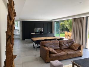 a living room with a couch and a table at Villa de standing dans le Golfe de Saint-Tropez in Grimaud