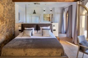a bedroom with a large bed in a room at Somnis de l´Empordà in Vilacolum