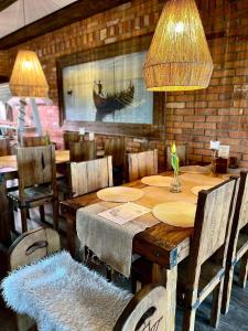 a dining room with a wooden table and chairs at Karczma Viking in Stara Kiszewa