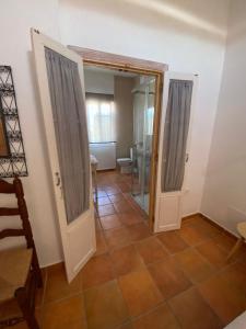 a bathroom with a toilet and a glass door at Hotel Casa Fina - Adults Recommended in Conil de la Frontera