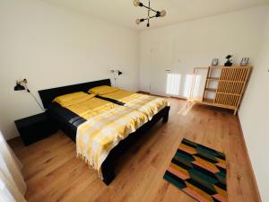 a bedroom with a bed and a wooden floor at Family M Apartments 4-5-6 in Kappel bei Olten