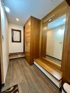 a hallway with wood paneling and a walk in closet at Singaras Coffee Country in Masinagudi +157 photos