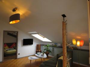 a living room with a couch and a bed at Ferienwohnung Lichtspiel - a58017 in Peiting