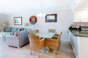 a kitchen and living room with a table and chairs at Sandpiper Dunes 109 in Ocean City