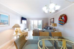 a living room with a couch and a table at Sandpiper Dunes 109 in Ocean City