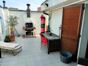 a patio with a fireplace and a table and a chair at THE ROOFTOP in Pero