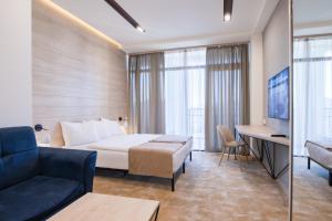 a hotel room with a bed and a couch at Rooftop Apart-Hotel in Yerevan +134 photos