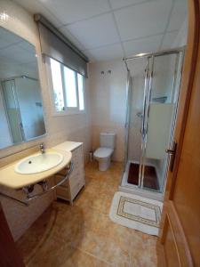 a bathroom with a sink and a shower and a toilet at URBANIZACION MIRAMAR PENISCOLA in Peñíscola