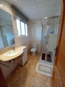 a bathroom with a sink and a shower and a toilet at URBANIZACION MIRAMAR PENISCOLA in Peniscola