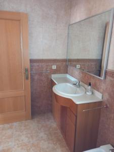 a bathroom with a sink and a mirror at URBANIZACION MIRAMAR PENISCOLA in Peñíscola