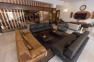 a large living room with couches and a tv at Dilshad Palace Hotel in Duhok