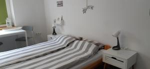 a bedroom with a bed and a lamp on a night stand at Master Corner Apartment in Krakow