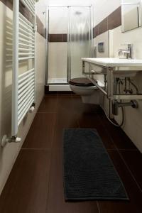a bathroom with a toilet and a sink and a shower at B&B ARCOVEGGIO in Bologna