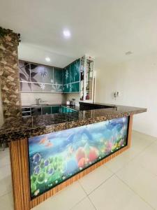 a kitchen with an aquarium in the middle of a room at Homelite Resort in Miri