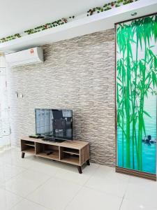 a living room with a large mural of bamboo at Homelite Resort in Miri