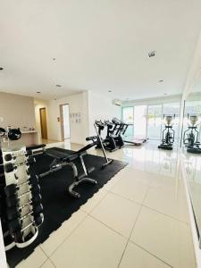 a gym with several treadmills and elliptical machines at Homelite Resort in Miri