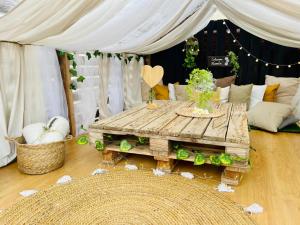 a wooden table in a living room with a tent at Lykke Suite Spa Piscina y Jardín by Deihu Experiences in Buzanada +88 photos