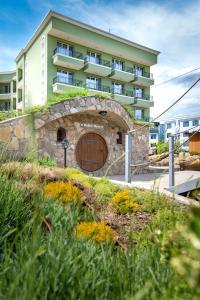a large building with a wooden door in front of a building at Glamping Alliance Hotel in Plovdiv