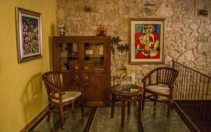 a dining room with a table and chairs and a stone wall at El Soportal de Uceda in Uceda