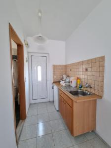 a kitchen with a sink and a counter top at White rose in Kámpos