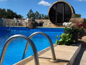 a resort swimming pool with a pooliteratoriteratorython at Macaronesia Love Spa, sauna y piscina in Buzanada